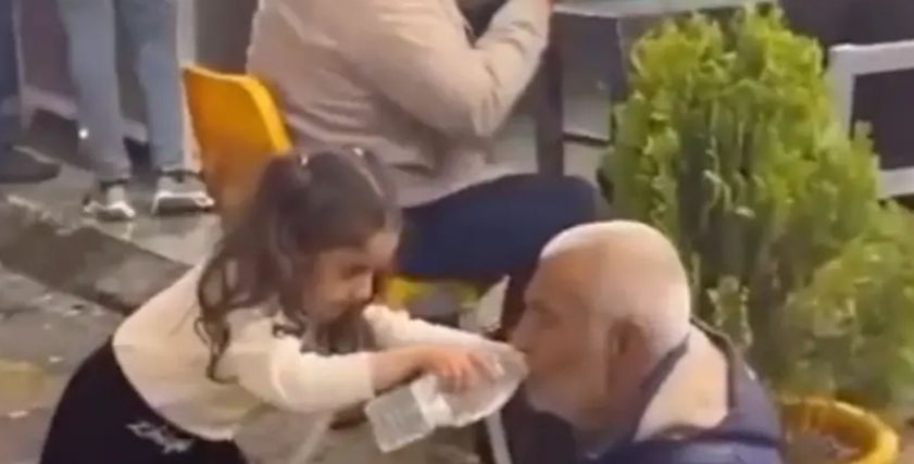 طفلة عراقية مع مسن مشرد